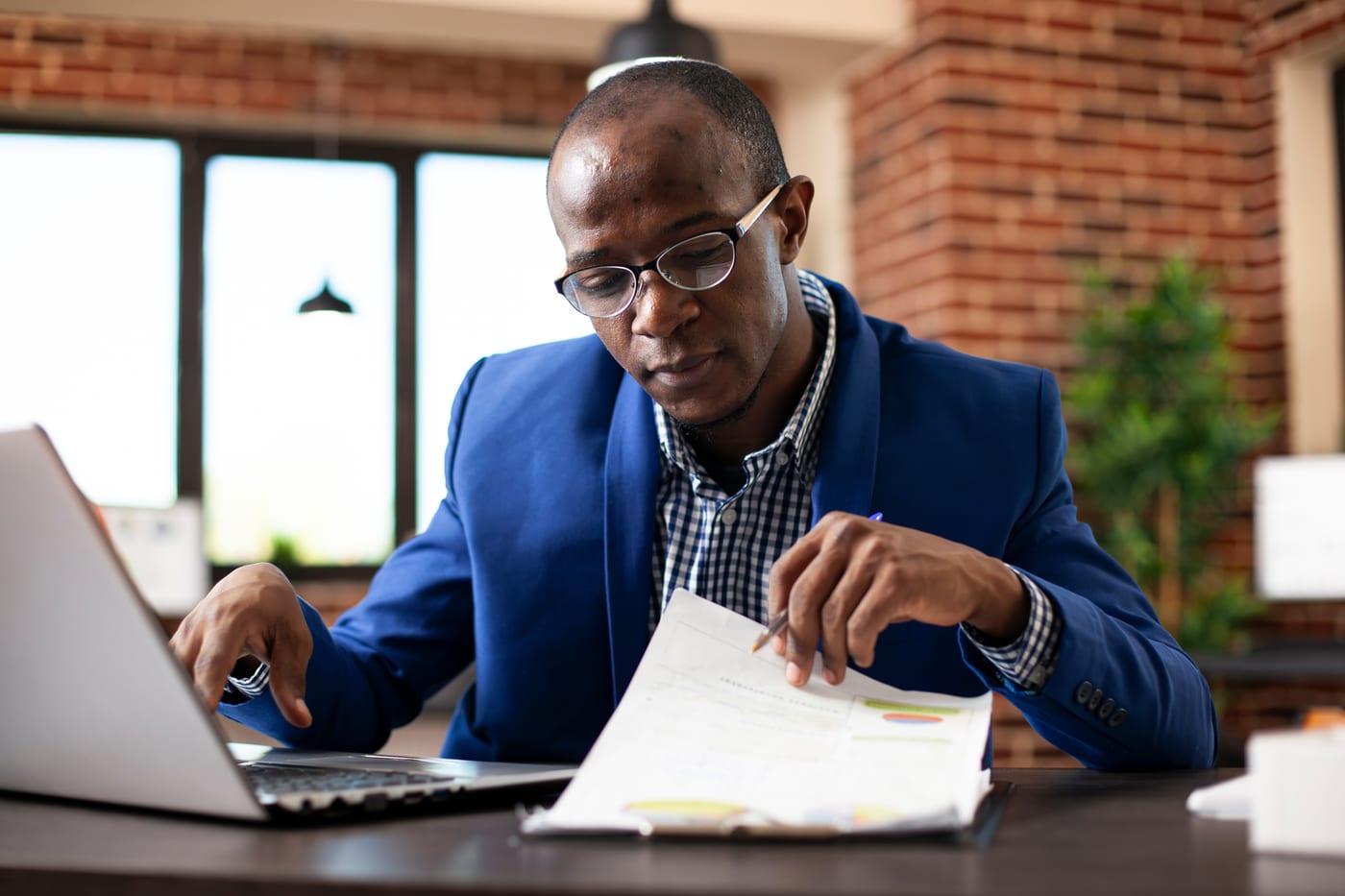 Business owner reviewing accounts receivable and cash-flow reports